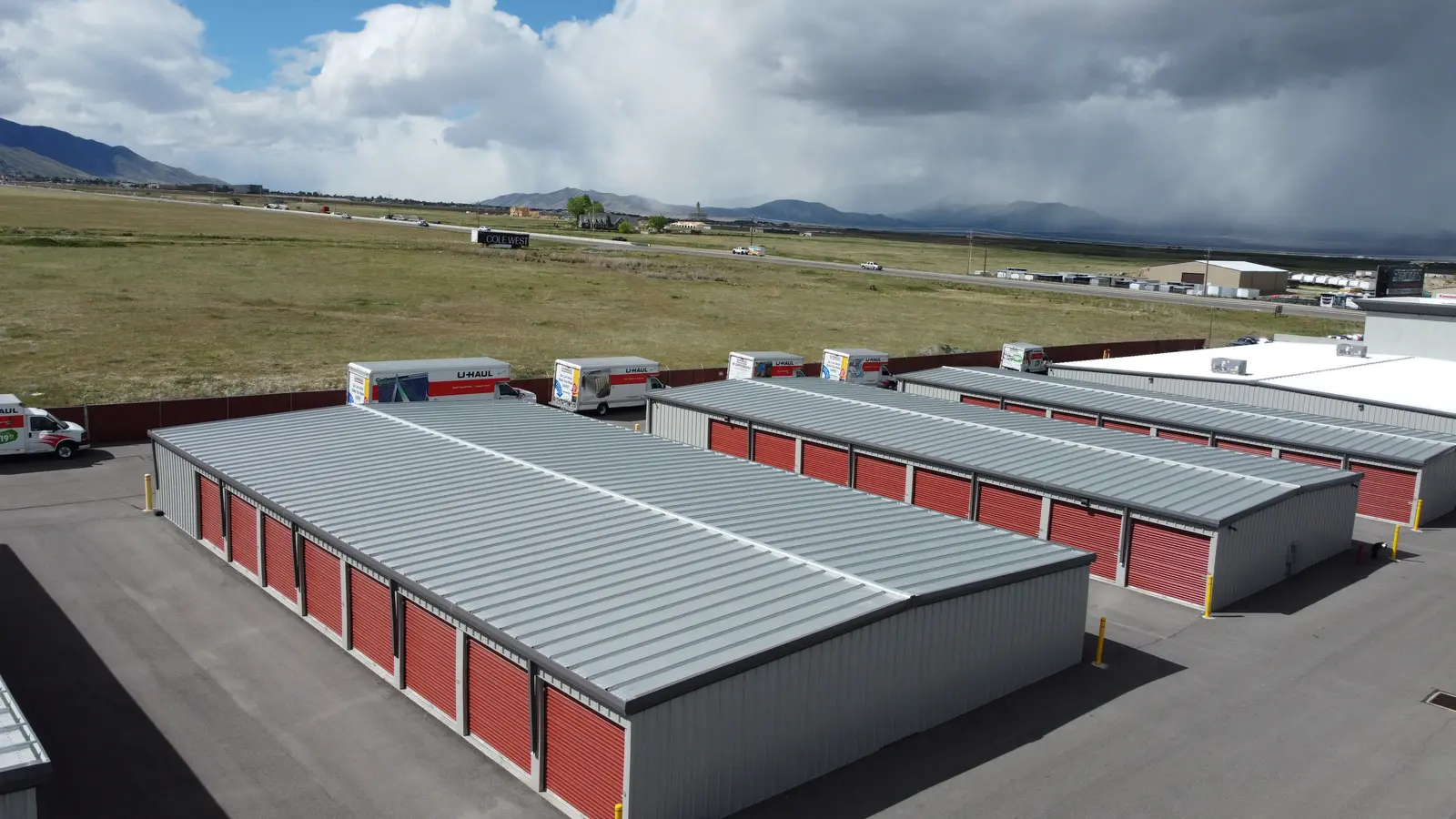 Red-door steel self-storage buildings along the highway in Erda, Utah