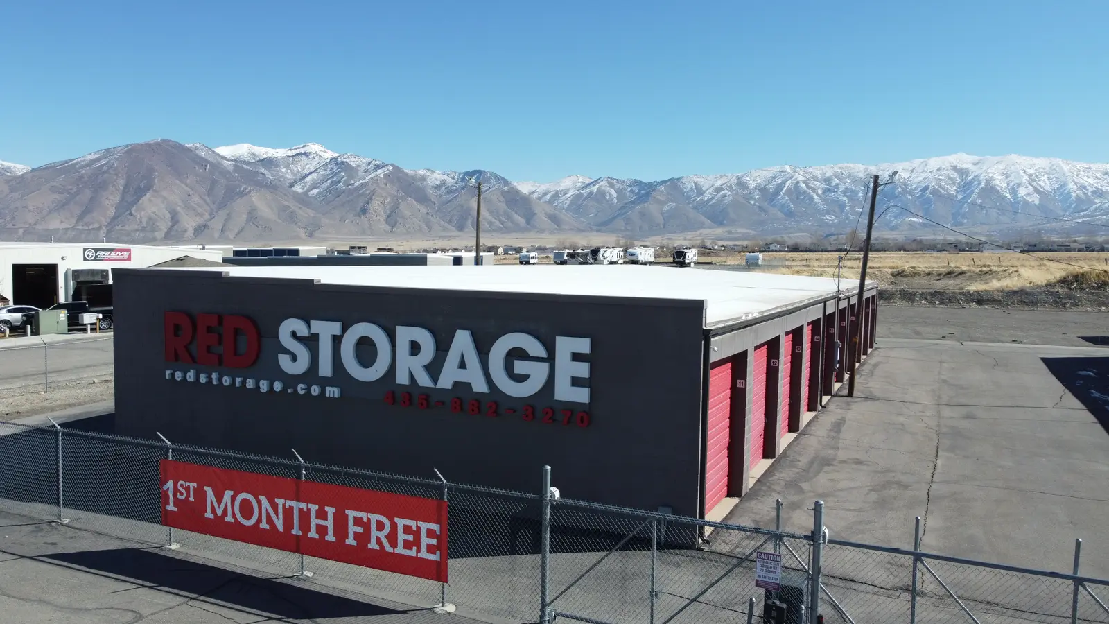 Red Storage steel self-storage building in Tooele, Utah, with the Stansbury Mountains behind