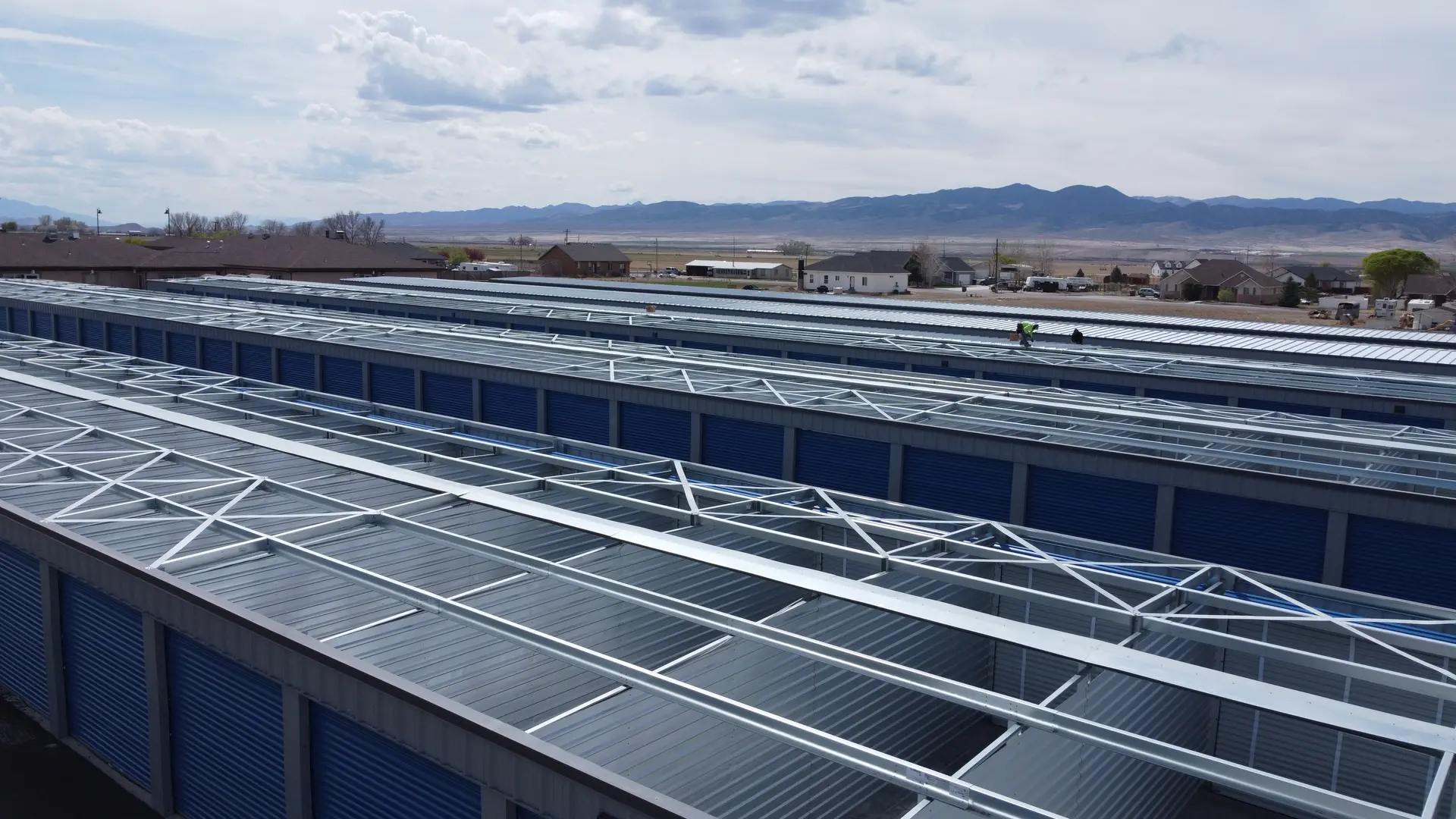 A self-storage building kit going up, long run of pre-engineered steel framing on site