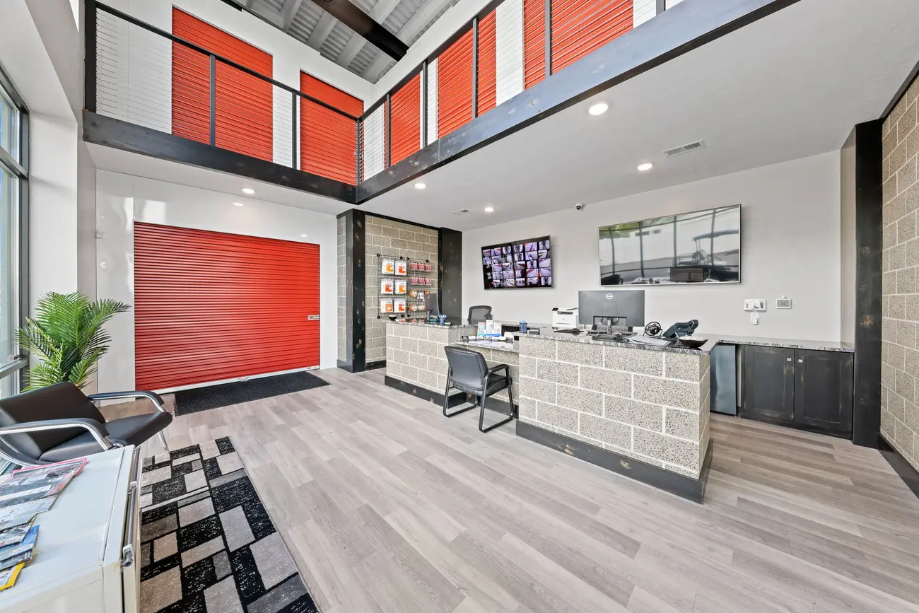 Climate-controlled self-storage leasing office interior with roll-up unit doors